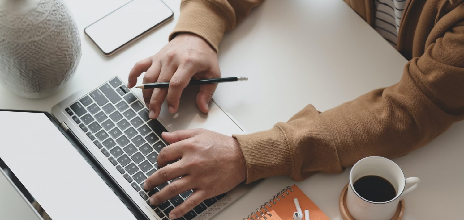 Person typing on keyboard to clear email inbox