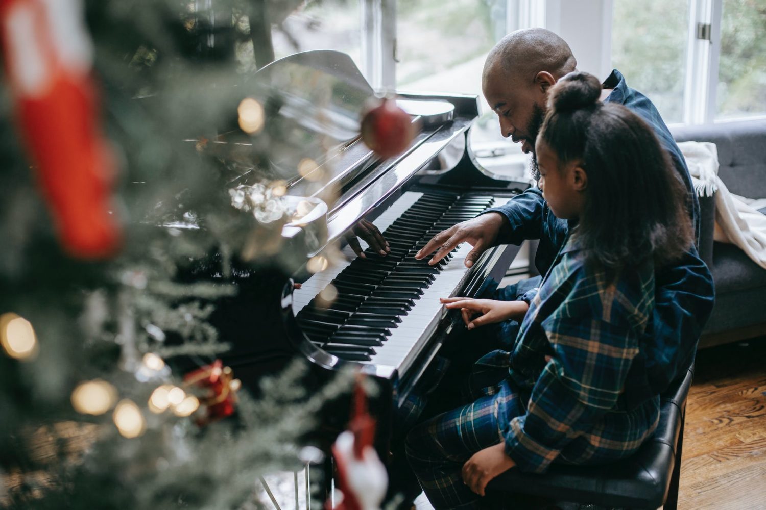 father and daughter playing piano